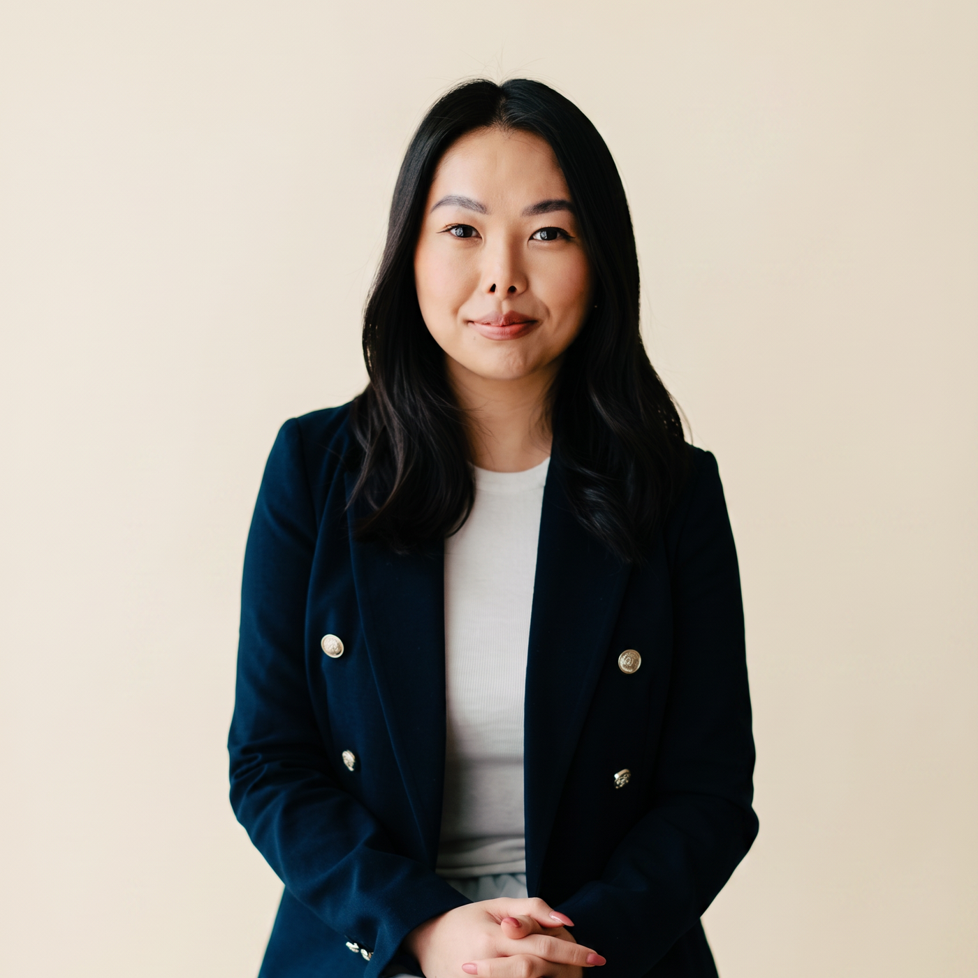 Elizabeth, founder of Reshape Admin, studio portrait on a warm cream backdrop